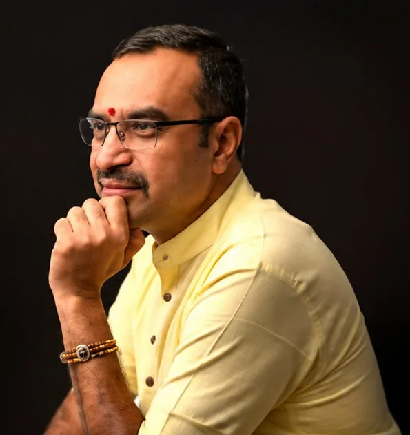 Portrait of Subhash Iyer, chin resting on his hand